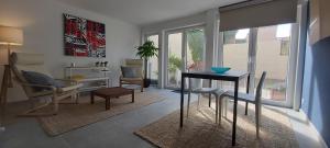 a living room with a table and chairs at Seagarden by Valdemosa in De Haan