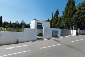 a white house on the side of a road at "Cozy" y con terraza en el centro de CADAQUÉS in Cadaqués +11 photos