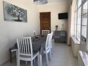 a dining room with a table and two chairs at Villa Maria Alvor in Alvor