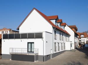 a row of white buildings with red roofs at Hotel zum Rössel in Kandel