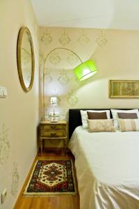 a bedroom with a bed and a table with a mirror at Enjoy Comfort in San Sebastián