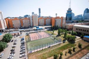 an aerial view of a parking lot with a tennis court at SKYAruna in Astana