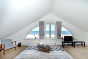 a bedroom with a bed and a large window at 't Spokeduin in Zandvoort