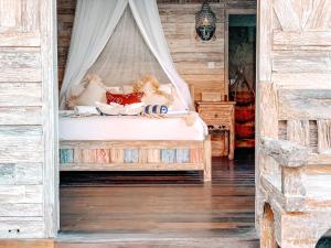 En eller flere senge i et værelse på Uluwatu Breeze Village