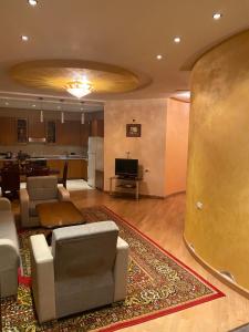 a living room with a couch and a table and a kitchen at House Abel in Tsaghkadzor