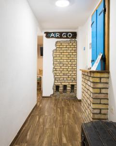 a room with a brick wall and a fireplace at Sobe Argo Izola in Izola
