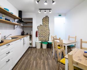 a kitchen and dining room with a table and chairs at Sobe Argo Izola in Izola
