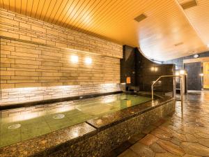a swimming pool in the middle of a building at APA Hotel Hiroshima-Ekimae Ohashi in Hiroshima