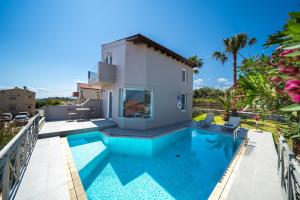 a villa with a swimming pool and a house at Lofos Village Chania in Agia Marina Nea Kydonias