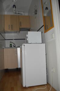 a small kitchen with a white refrigerator in it at Estudio Puerta del Sol Esparteros in Madrid