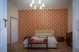 a bedroom with a bed and a chandelier at L'Antica Caiatia in Caiazzo