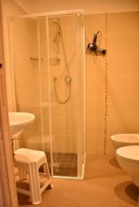 a bathroom with a shower and a sink and a toilet at Hotel Marisa in Riccione +23 photos