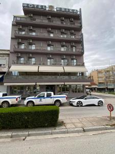 
two cars parked in front of a building at Hotel Erika in Alexandroupoli
