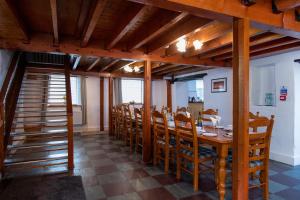 a dining room with a long table and chairs at Bryn Llys for the Zip Wire in Bethesda