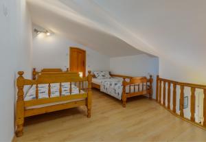 a bedroom with two beds and a staircase at Apartments Josipovic in Fažana