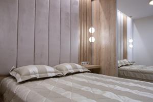 a bedroom with a large bed with two pillows at Central Apartment Marianthe in Ioannina
