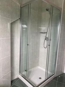 a shower with a glass door in a bathroom at Ático en Tapia de Casariego con vistas a la playa. in Tapia de Casariego