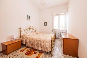 a bedroom with a bed and a dresser and a window at Casa Vacanze Cattolica in Cattolica