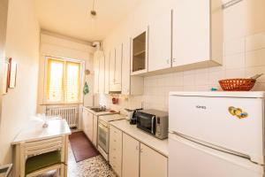a kitchen with a refrigerator and a microwave at Casa Vacanze Cattolica in Cattolica