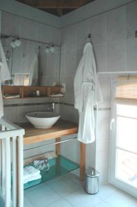 a bathroom with a sink and a white towel at Manoir des Chanterelles in Meauzac