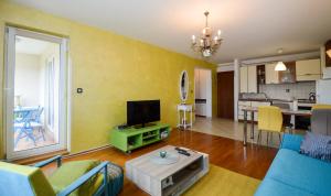 a living room with a blue couch and a tv at Lungo Mare in Pula +22 photos