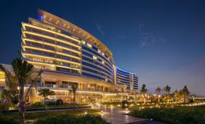 a large building with lights in front of it at Grand Hyatt Kochi Bolgatty in Cochin