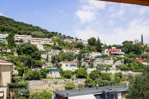 a village on a hill with houses at Les Mimosas in Roquebrune-Cap-Martin
