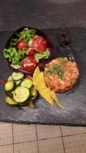 un plato de comida con patatas fritas y verduras en una mesa en Hotel Aurora, en Porto Cesareo