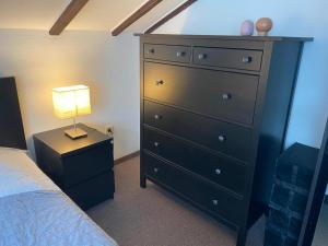 a bedroom with a dresser and a bed with a lamp at Ferienwohnung Malk in Traben-Trarbach