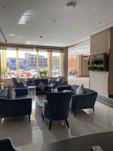 a lobby with couches and chairs in a building at Seven Garden Palace in Taif