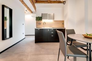a kitchen and dining room with a table and chairs at Black & White Apartments in Rijeka