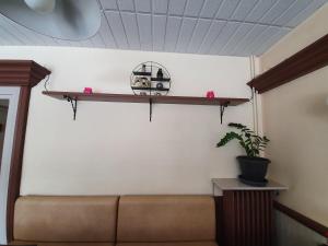 a room with a couch and a shelf on the wall at Hotel De La Poste in Espinasses