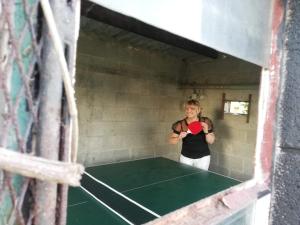 a man holding a ping pong ball in a tunnel at Chez Peponne in Dinant