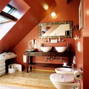 a bathroom with two sinks and a mirror at Relais & Châteaux Taubenkobel in Schützen am Gebirge +49 photos