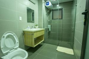 a bathroom with a shower and a toilet and a sink at DaLaHa City in Da Lat +32 photos