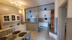 a kitchen with a table and a dining room at Ilike Home in Balatonfüred