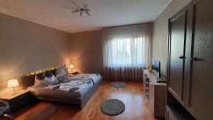 a bedroom with a bed and a television in it at Ilike Home in Balatonfüred
