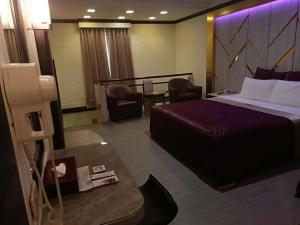 Postel nebo postele na pokoji v ubytování Xin Yuan Motel