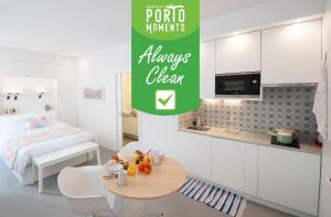 
a kitchen with a table and a refrigerator at Porto Moments Apartments in Vila Nova de Gaia
