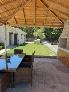 a patio with a wooden pergola and a table and chairs at Lasa Valley Villa in Lasa