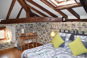 a bedroom with a bed and a desk in a room at Chambre d'Hôtes Moulin Urketa in Ayherre +39 photos