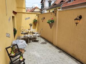 a patio with a table and chairs in a courtyard at Smiley Rezident in Sibiu