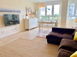 a living room with a couch and a table at Apartamento Valdenoja Playa Sardinero in Santander