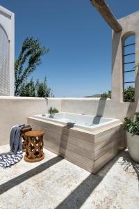 a hot tub sitting on the side of a house at Jasmine Holiday Villa in Episkopi