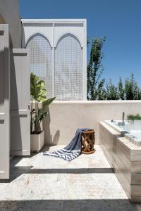 a bathroom with a tub and a sink and a tub at Jasmine Holiday Villa in Episkopí- Rethimno