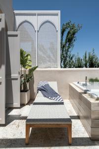 a bathroom with a bench and a bath tub at Jasmine Holiday Villa in Episkopí- Rethimno