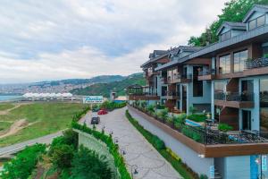 an apartment building with a walkway next to a river at Peerless Villas Hotel in Trabzon