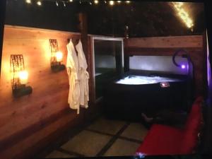 a room with a hot tub in a wooden house at Amante Luxury Bed & Breakfast in Victoria