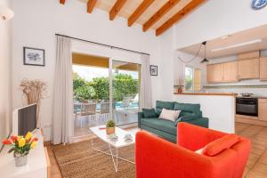 a living room with a couch and a table at Villa Laura in Cala en Forcat