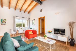 a living room with a couch and a table at Villa Laura in Cala en Forcat